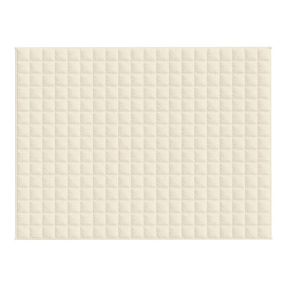 The quilted pattern of a light cream blanket