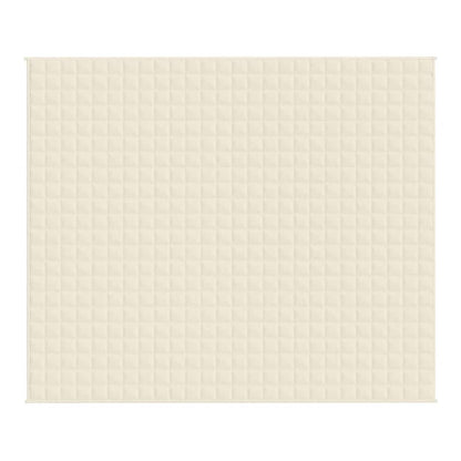A close-up of the quilted texture of the light cream blanket