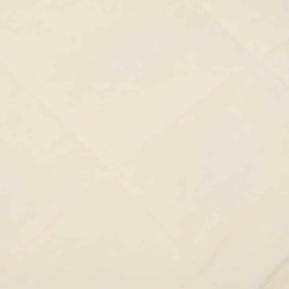 A close-up of the light cream fabric texture