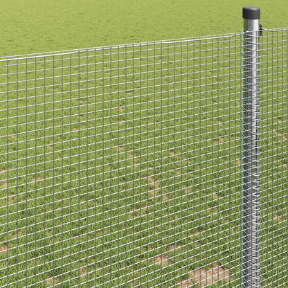 Close-up view of the welded wire fence mesh and a metal support post in a garden setting