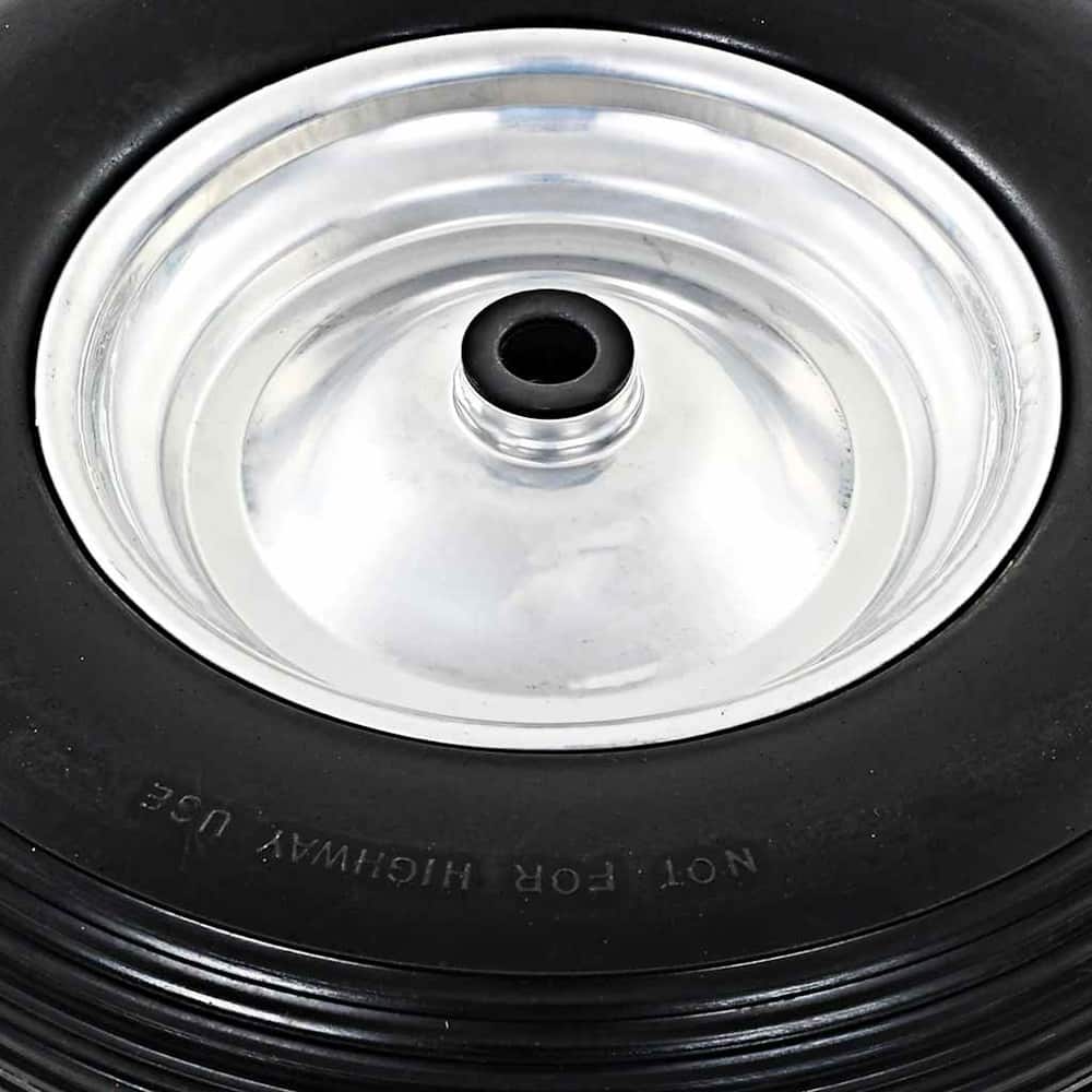 Close up of the silver metal rim and black centre of a wheelbarrow wheel