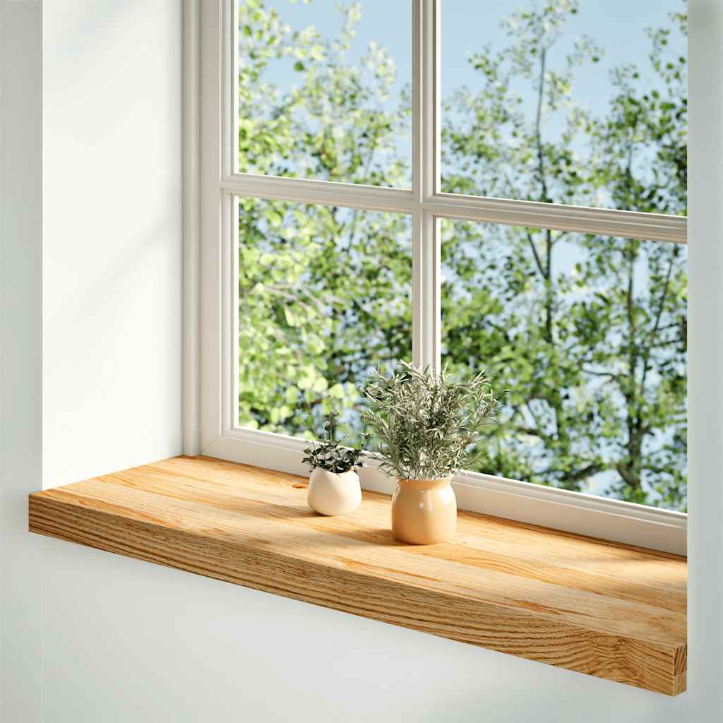 The light brown wooden window sill installed in a room with plants on it
