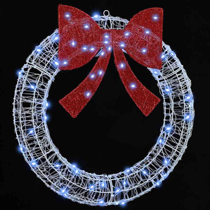 The illuminated festive wreath glowing brightly against a dark background