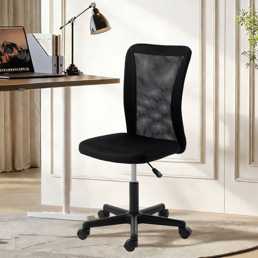 The black mesh office chair positioned under a desk with a laptop on it in a home office setting