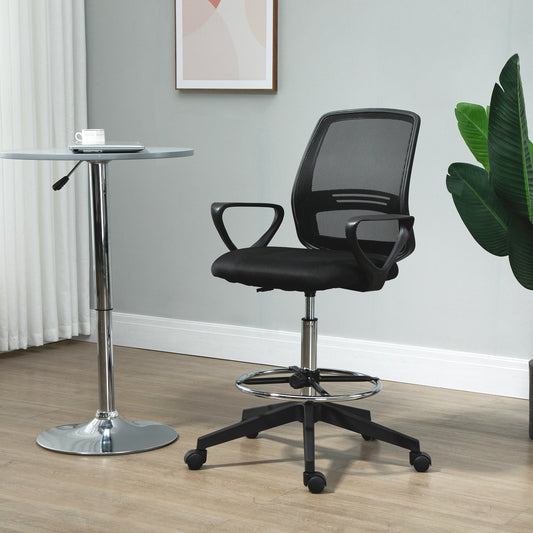 The office chair placed in a bright room next to a tall standing desk