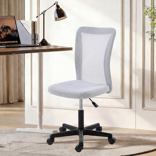 The office chair placed in a bright home study next to a desk with a laptop and lamp