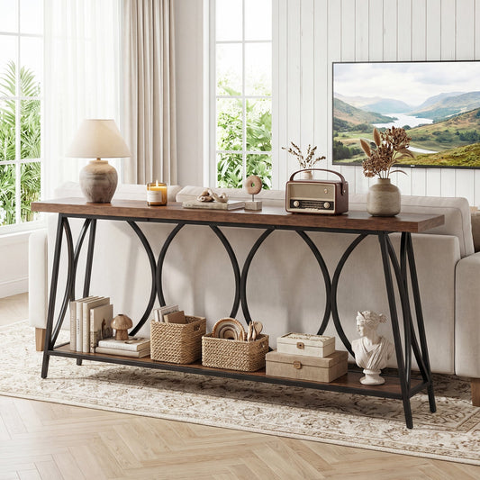 The console table in a living room behind a sofa, styled with books and decor