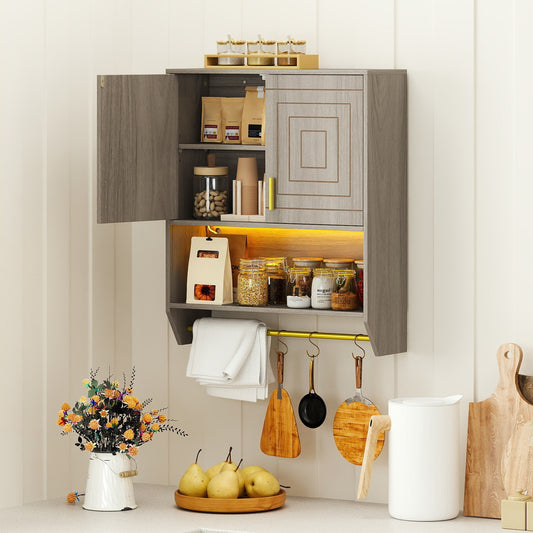 Wall cabinet with doors open, showing storage shelves filled with jars and towels, with a towel rail below
