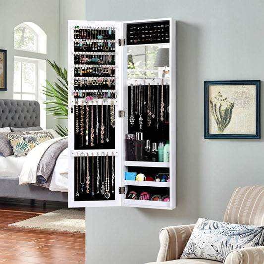 White jewellery cabinet with mirror, shown hanging on a bedroom wall