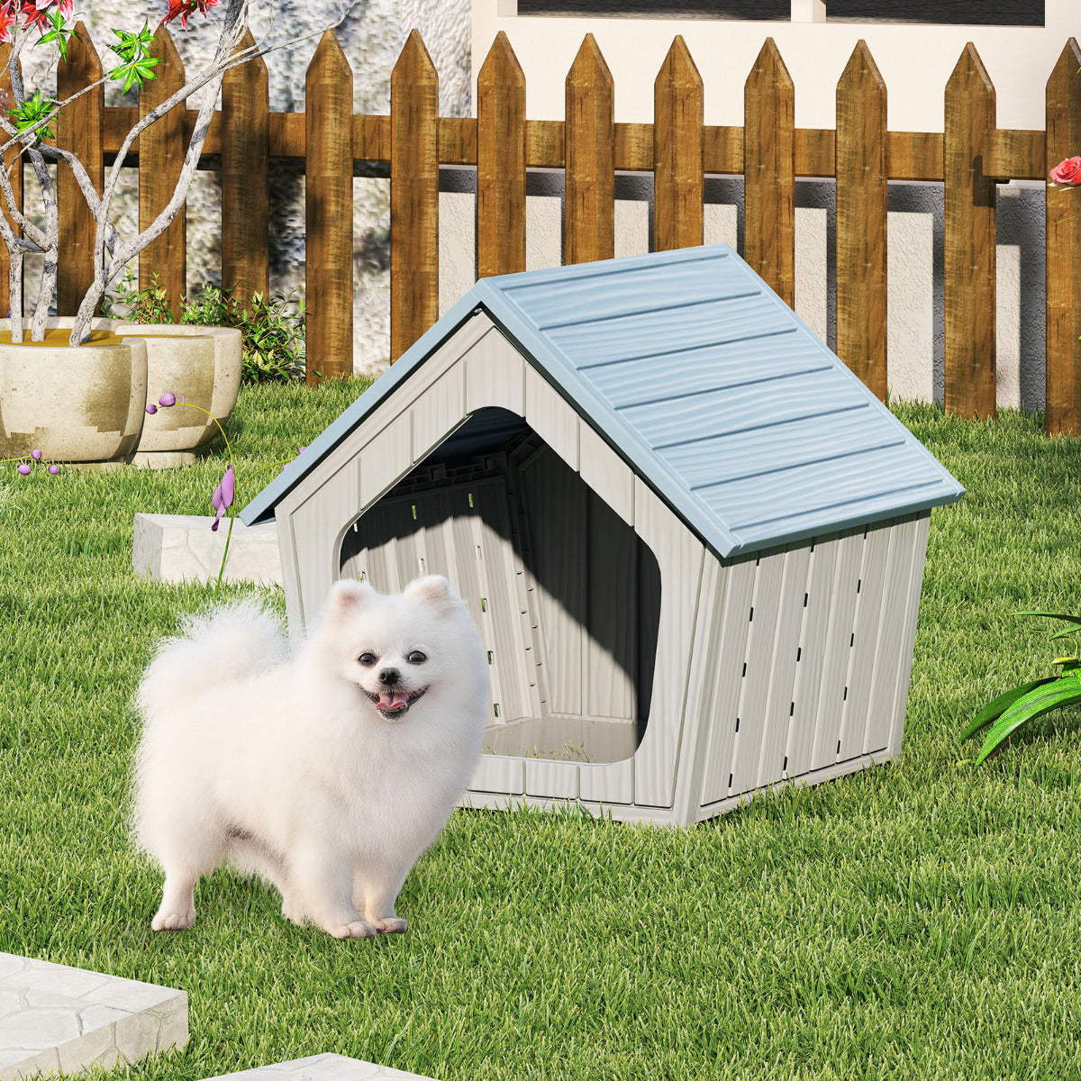A fluffy white dog stands on green grass in front of the blue and grey plastic cat house