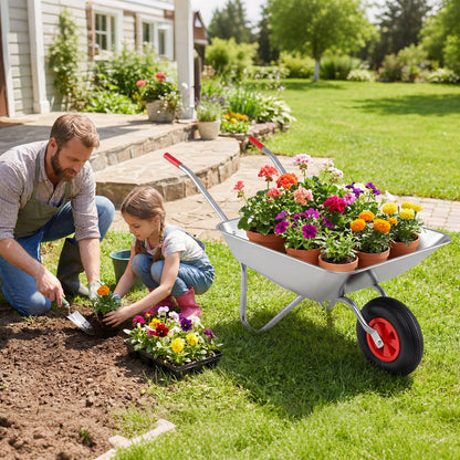 A man and a girl planting flowers in a garden with the wheelbarrow cart nearby