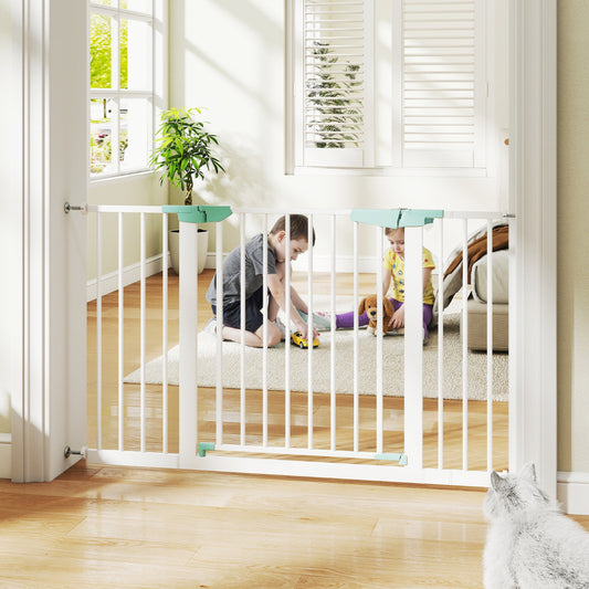 The white baby safety gate is installed in a doorway, with two children and a cat nearby