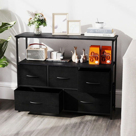 The chest of drawers in a living room with two drawers pulled out and home decor on top