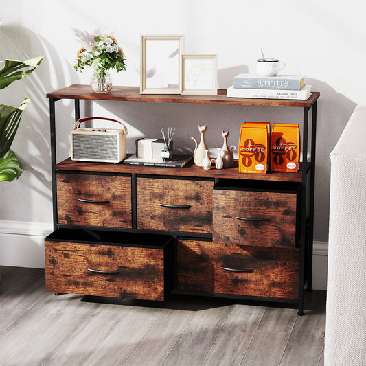 The wide chest of drawers styled with books and decorative items