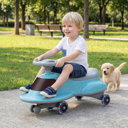 The blue wiggle car with multi-coloured wheels being steered by a young boy on a paved path