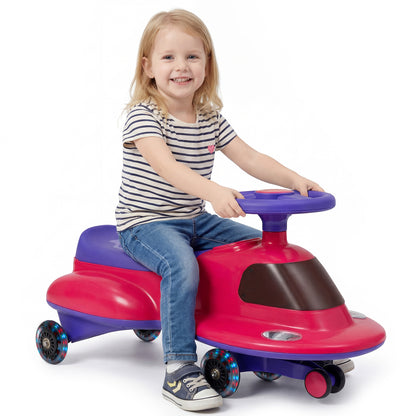 Wiggle Car with Under-seat Storage and LED Flashing Wheels in pink being ridden by a young girl