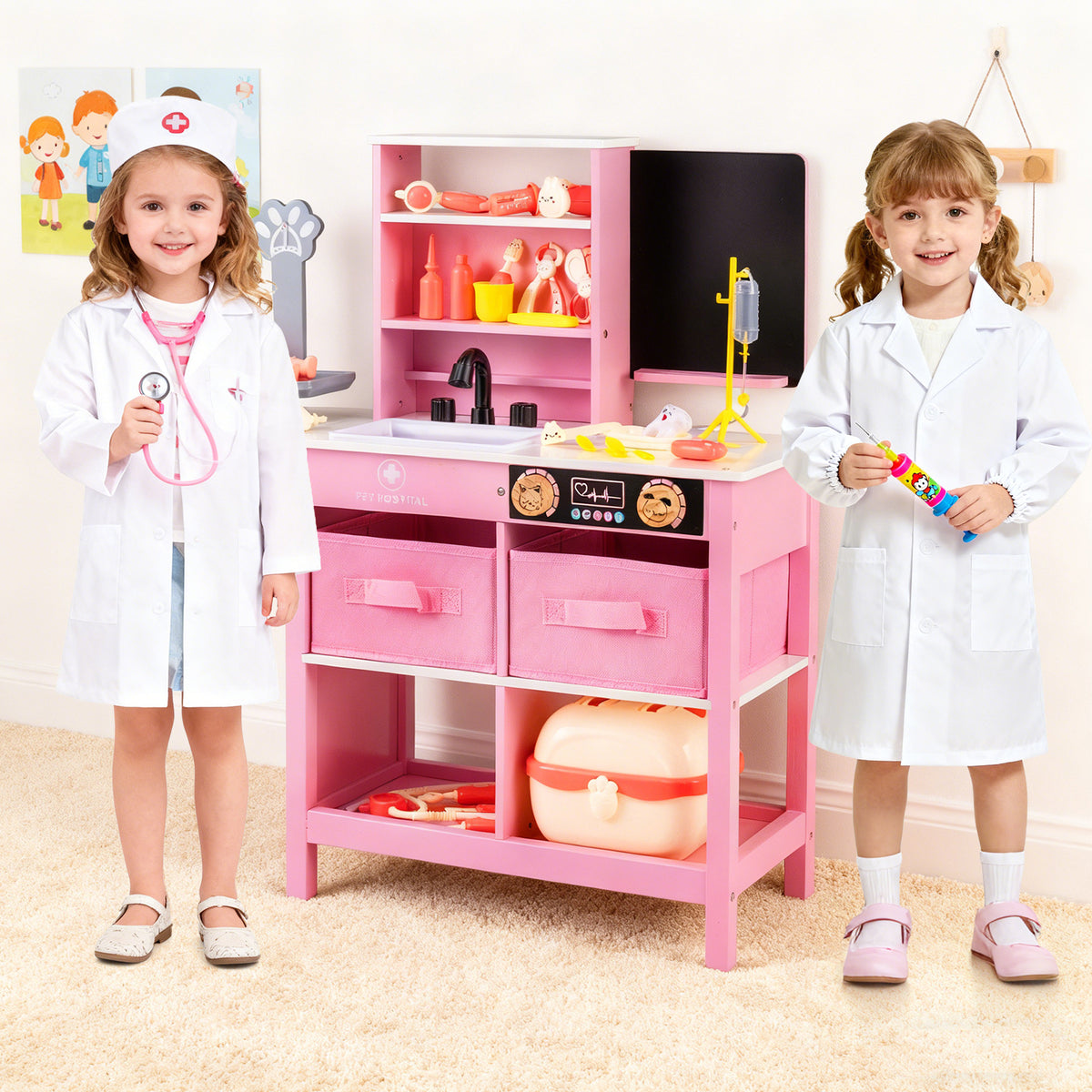 Two young children in white doctor coats standing next to the pink medical play station