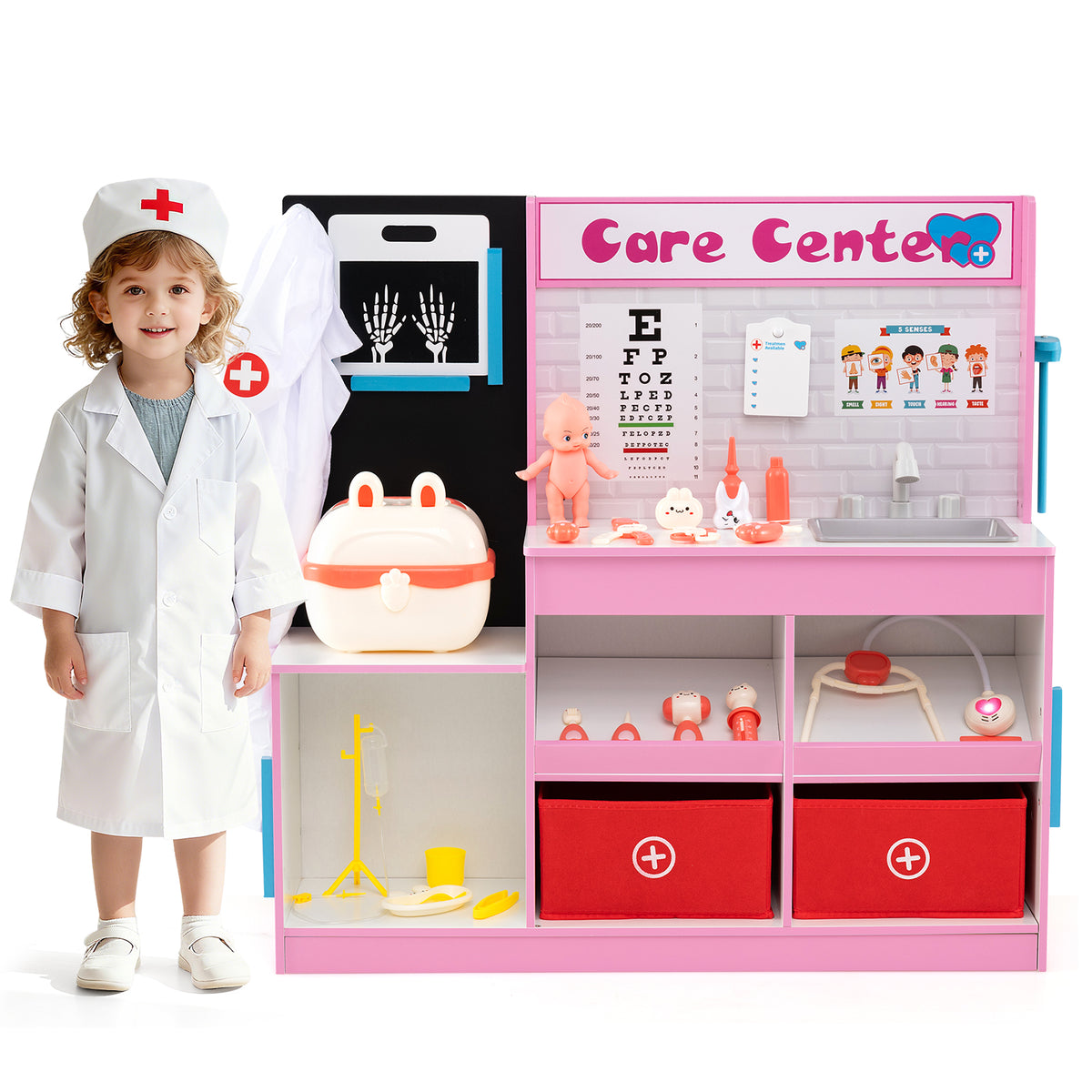 A child dressed as a doctor standing next to the pink wooden medical centre toy