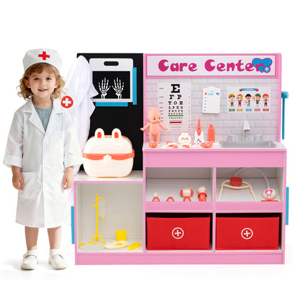 A child dressed as a doctor standing next to the pink wooden medical centre toy