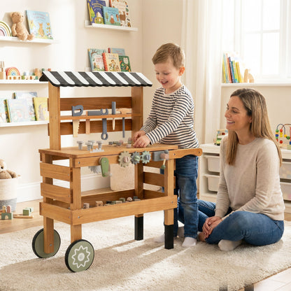 A mother and child interacting with the wooden play kitchen set indoors