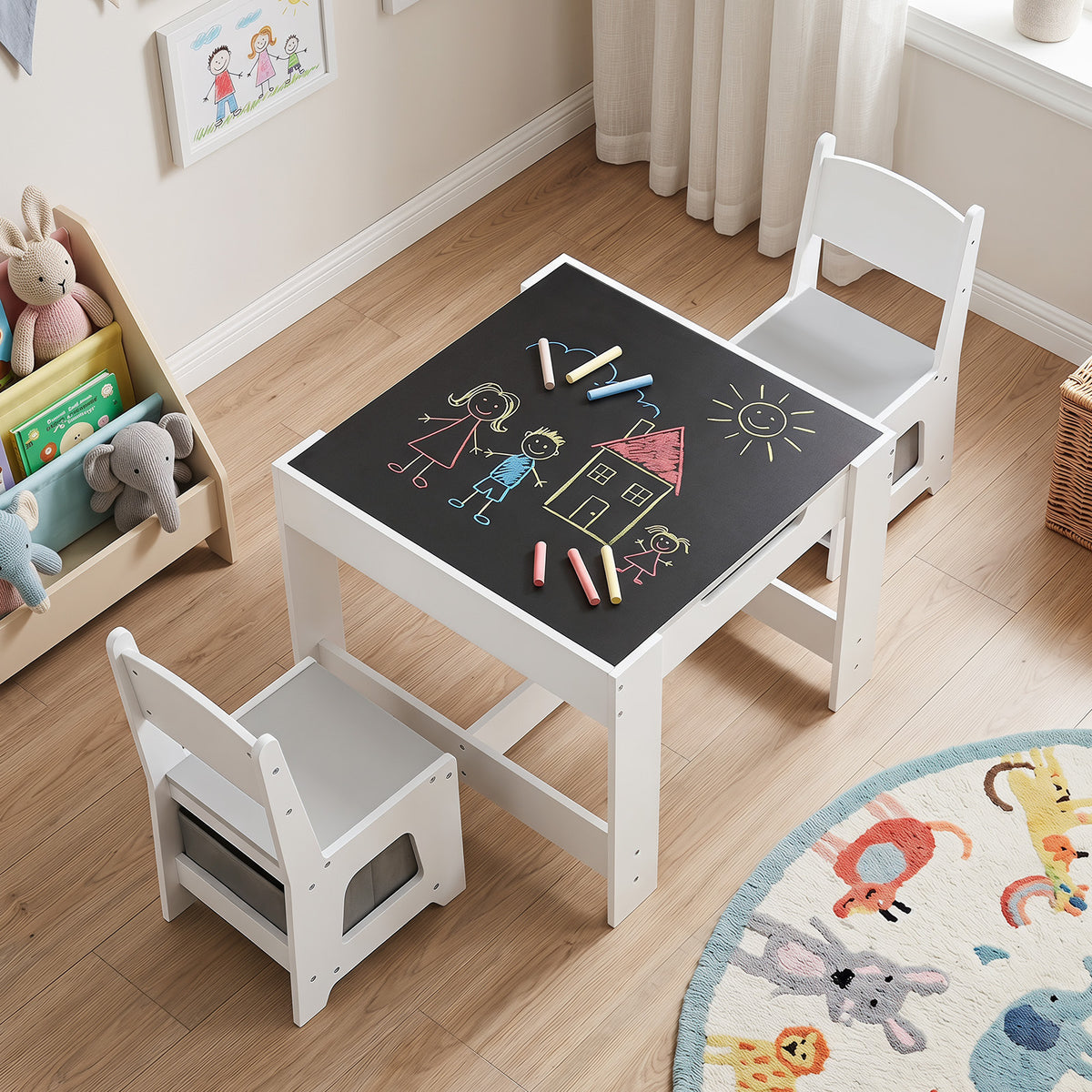 The kids table and chair set with the blackboard side facing up and colourful drawings