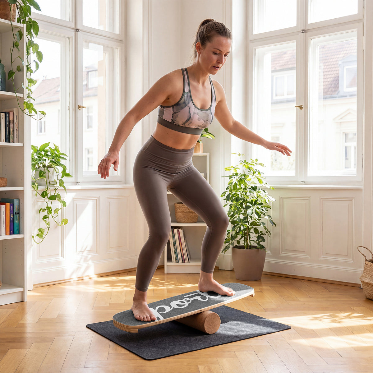 Woman using the wooden balance board trainer in a bright living room