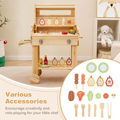 The play kitchen set displayed with a collection of wooden play food and cooking utensils