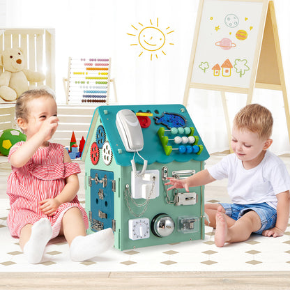 Two young children sitting on a play mat and interacting with the learning toy in a nursery