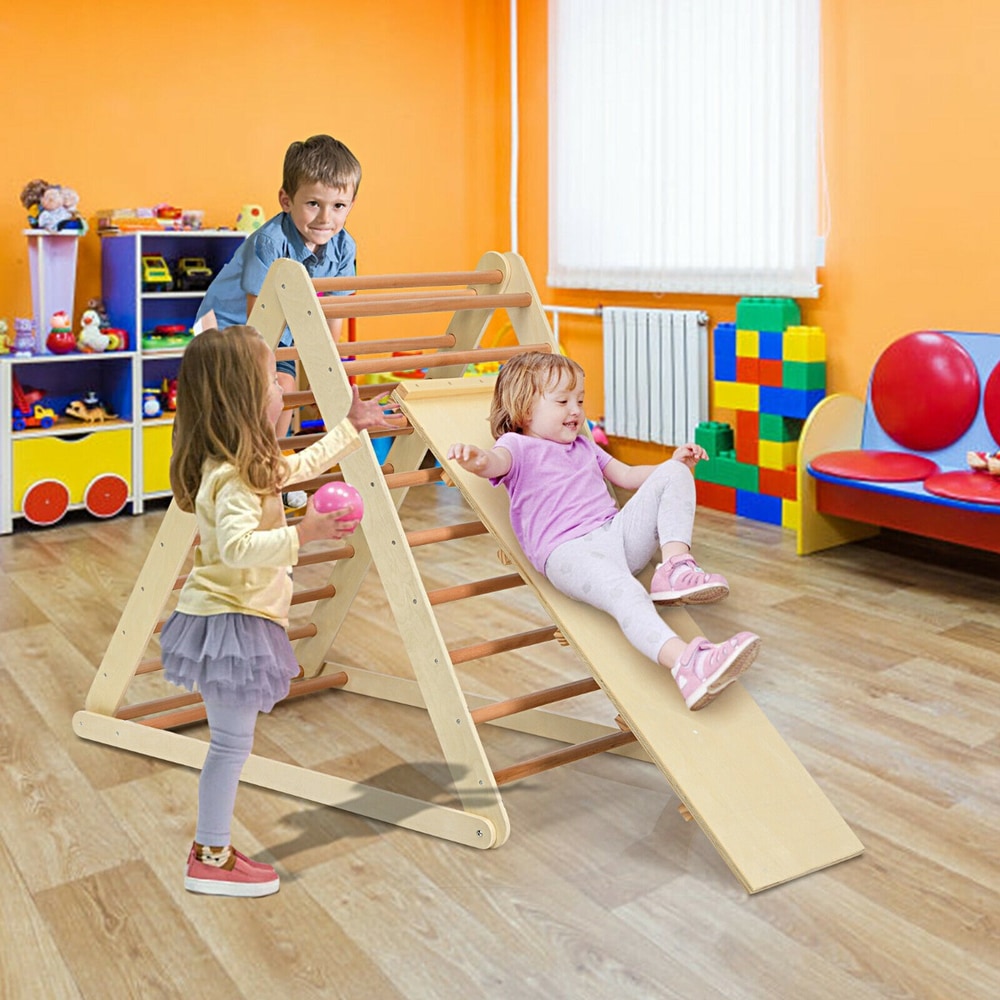 Children playing on the wooden climbing ladder with ramp in a bright kindergarten room