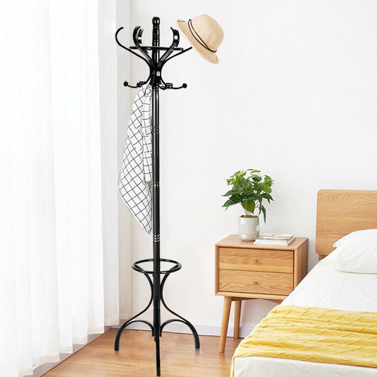 The coat rack standing in a bedroom next to a bedside table with a hat and scarf