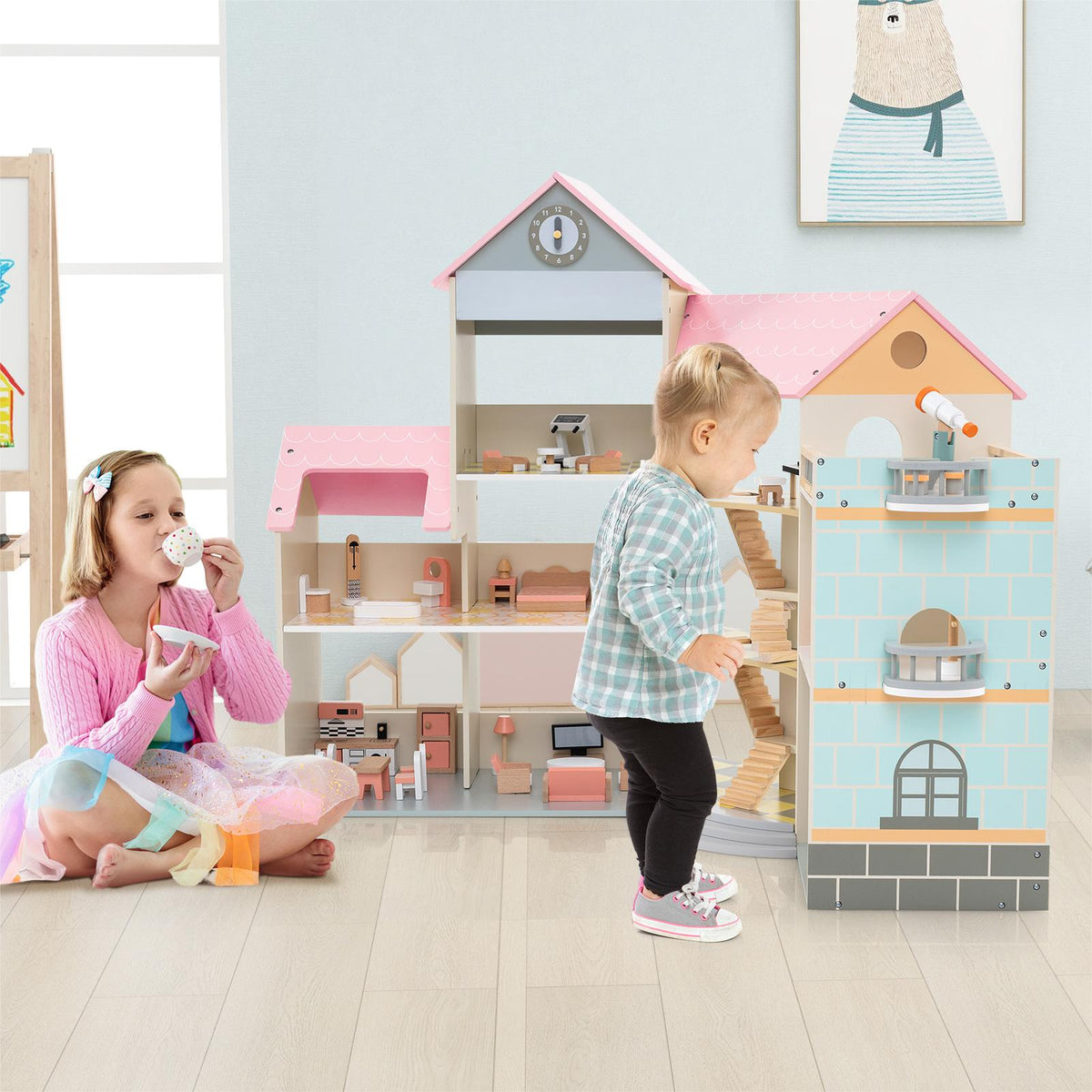 The wooden dollhouse next to a young girl having a tea party on the floor