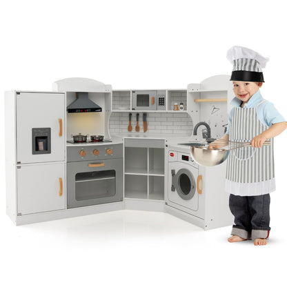 A boy pretends to cook at the wooden corner play kitchen