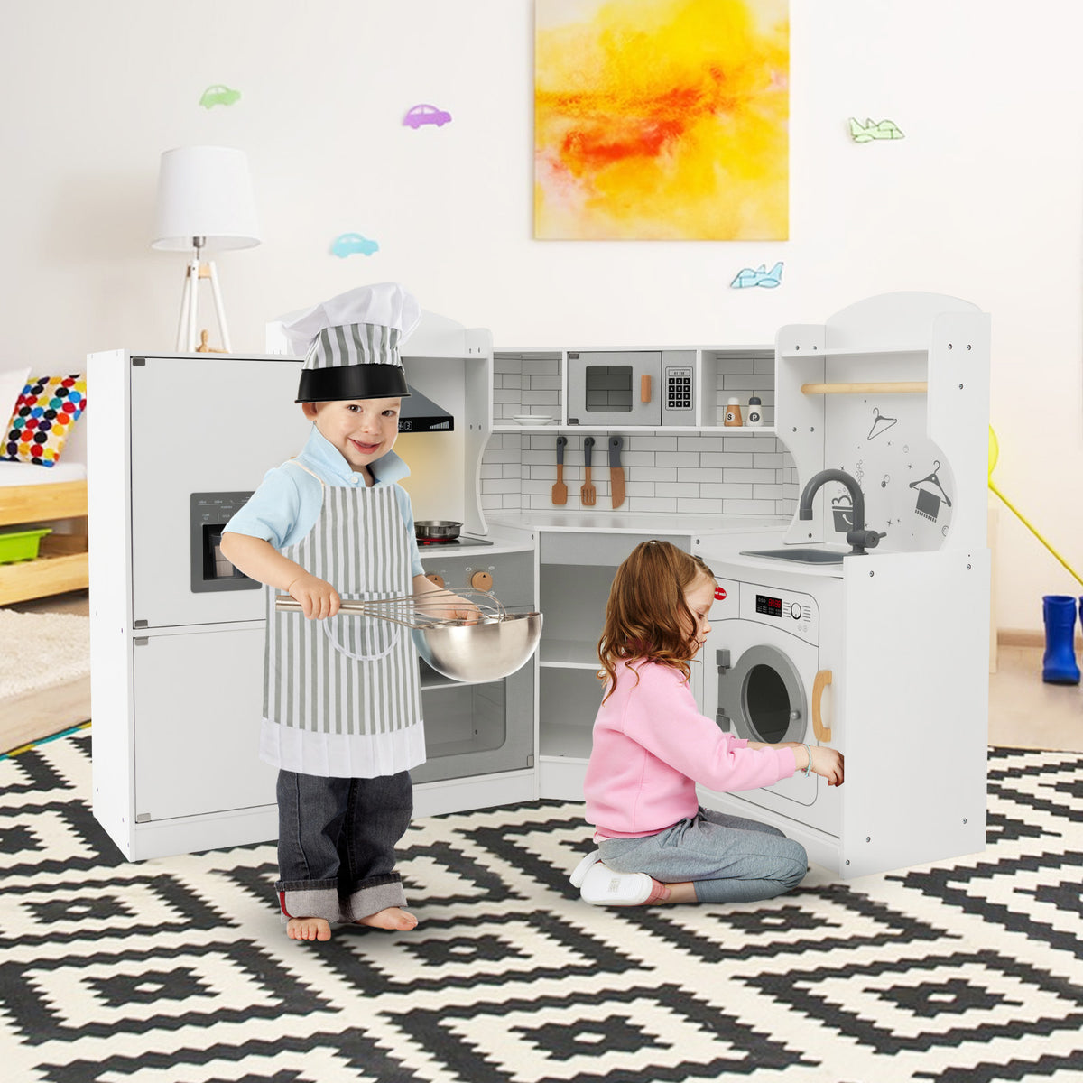 The play kitchen set being used by two children in a bright bedroom with a patterned rug