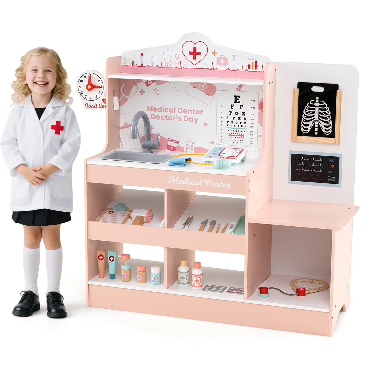 A young girl in a doctor's coat stands next to the pink wooden medical centre