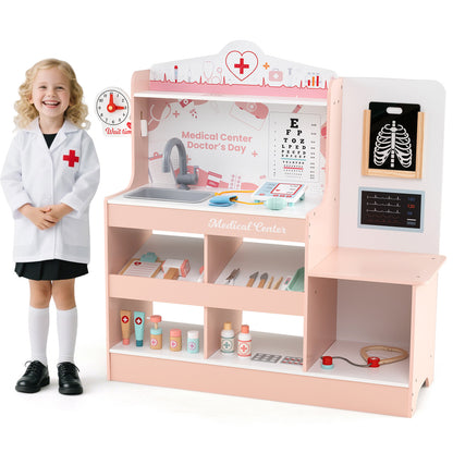 A young girl in a doctor's coat stands next to the pink wooden medical centre