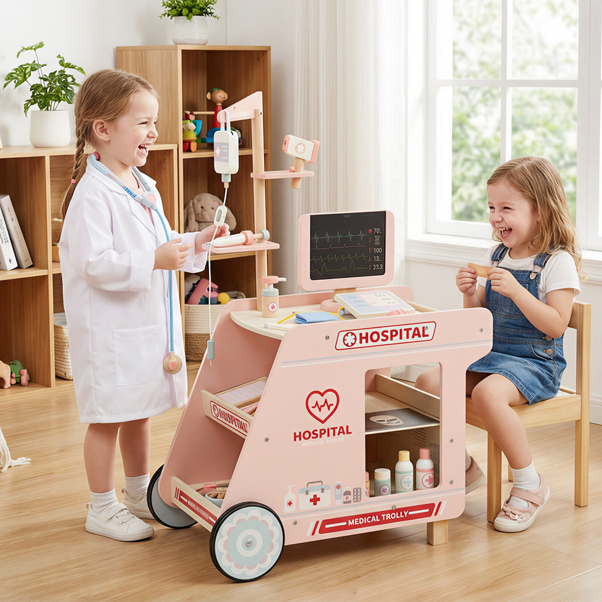 The pink medical trolley with two children playing doctor in a room