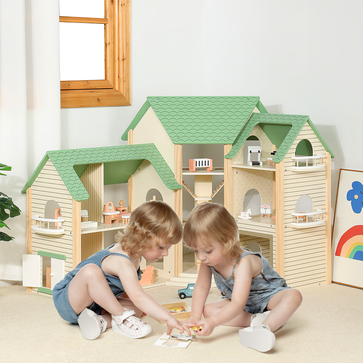 Two young children playing with the wooden dollhouse and accessories on the floor