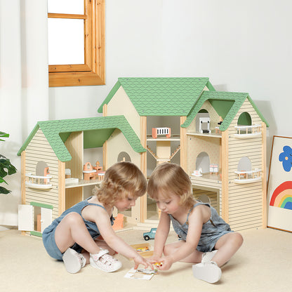 Two young children playing with the wooden dollhouse and accessories on the floor