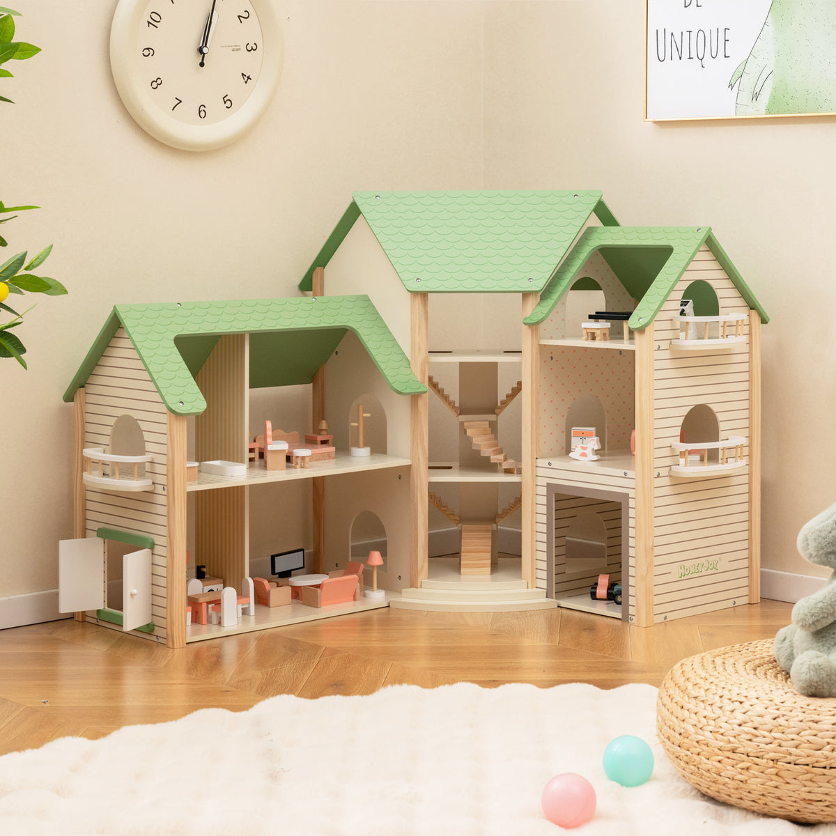 The wooden dollhouse with green roof has three storeys and open sides showing rooms and stairs