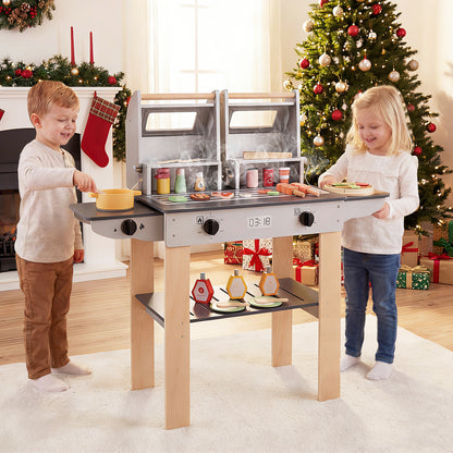Children playing with the wooden barbecue grill playset at Christmas