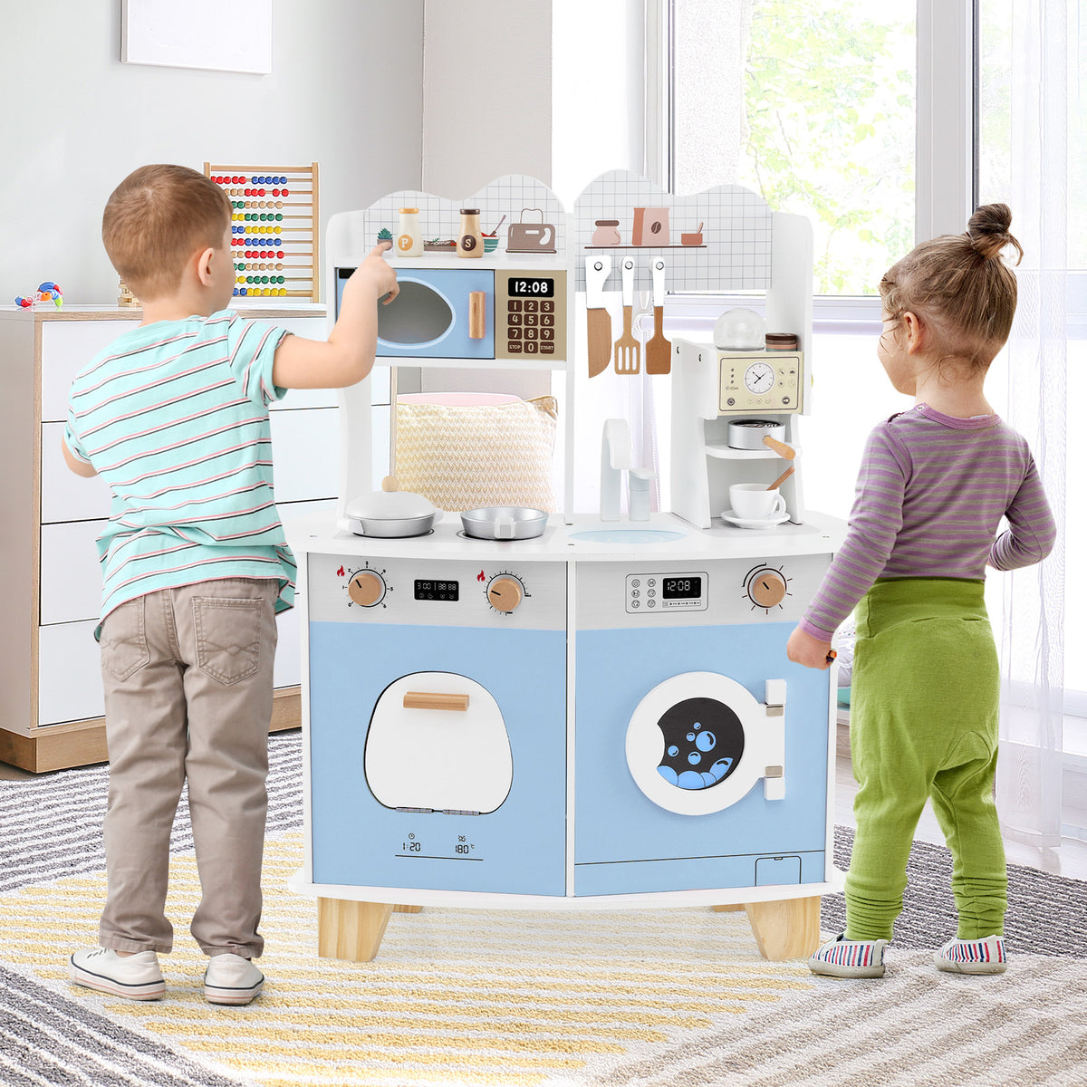 Children playing with the blue and white wooden play kitchen set in a room
