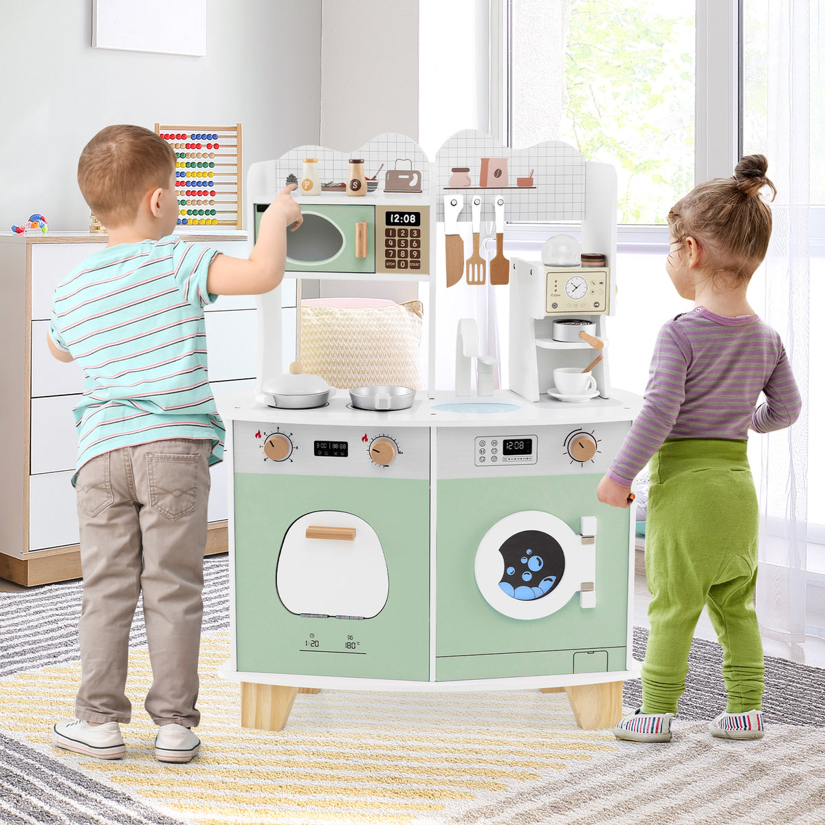 Two children playing with the play kitchen set in a bright room with a wooden floor