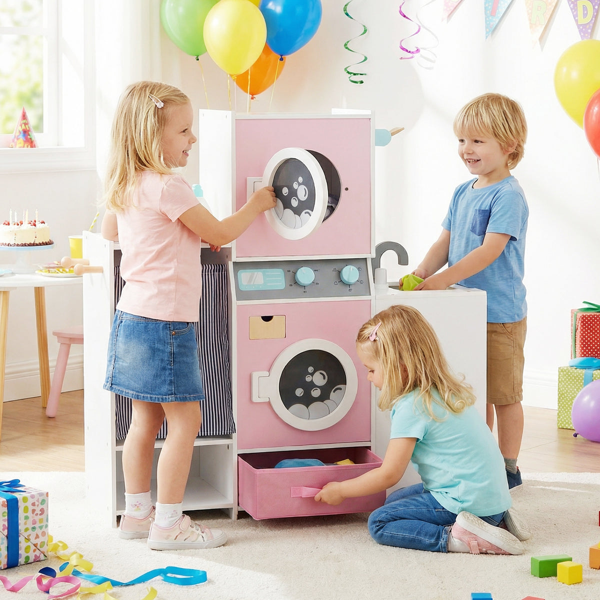 Children playing with the toy washing machine and laundry basket at a party