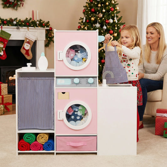 A mother and daughter playing with the pink toy washing machine in a festive room