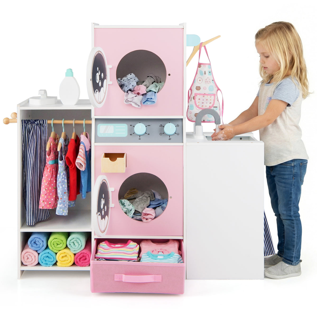 A girl playing with the toy washing machine and sink in a playroom