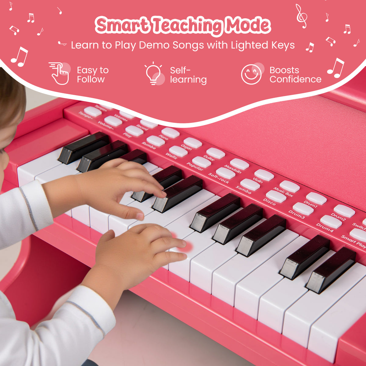 Close-up of a child's hands playing the keys of the pink wooden kids piano keyboard