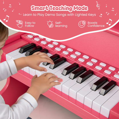 Close-up of a child's hands playing the keys of the pink wooden kids piano keyboard