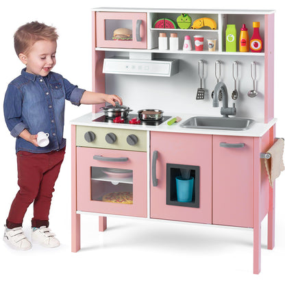 The play kitchen set with a young boy playing with the stove pots