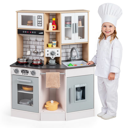 Girl in chef's uniform standing next to the wooden kitchen playset