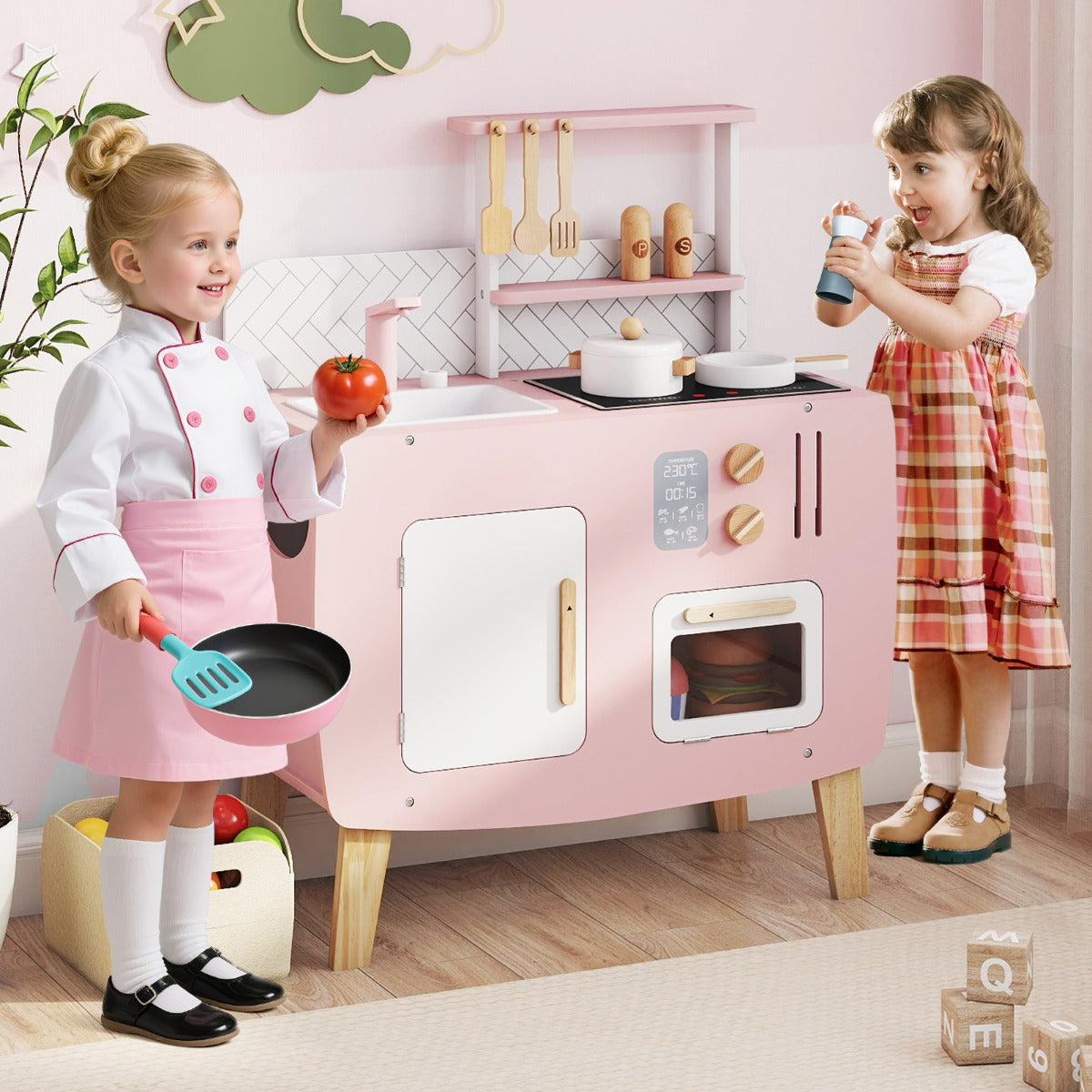 Two young girls playing with the play kitchen set in a home environment